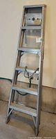 Full front view of folded aluminum step ladder