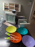 Overall lot showing boxed Pier 1 sets, coloured bowls, chopsticks packages, and stir sticks