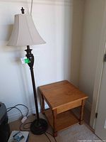 Wood side table and metal floor lamp together
