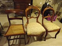 Front view of three chairs showing styles and seat types