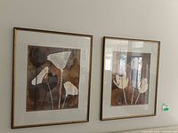 Both framed floral prints side by side on wall