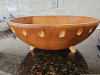 Exterior side view showing feet and carved dimples