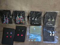 Overview of eight earring cards in packaging