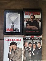 Front covers of the four DVD box sets arranged in two-by-two grid