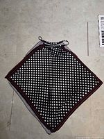 Black and white polka dot halter top laid flat