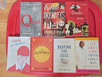 All seven paperback books arranged face-up showing covers and titles