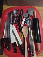 Group shot of all utensils laid on red lid