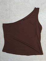 Brown one-shoulder sleeveless top, lying flat