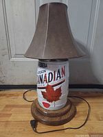 Front view of keg lamp showing Molson Canadian graphics, wood base, brown shade, power cord