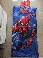 Sleeping bag front showing Spider-Man graphic and carry bag