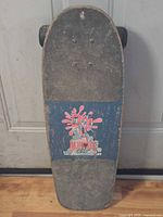 Full view of skateboard showing deck, grip tape, wheels
