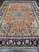 Full view of Persian rug showing overall pattern and borders