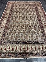 Full view of Persian rug showing overall design and borders