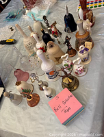 Overview of approximately 30 assorted bells on table