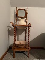 Full view of washstand showing mirror, pitcher, top basin, lower basin