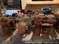Group shot of all eight steins on countertop