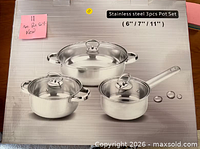 Front of unopened box showing three-piece stainless steel pot set illustration
