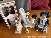 Group shot showing all dolls and figurines on table
