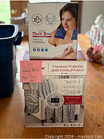 Stacked unopened boxes of heated throw and Magic Bag