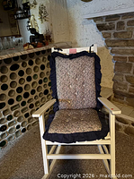 Front view of rocking chair showing cushions and frame