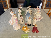 Group view of all ten Royal Doulton figurines on table
