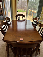 solid wood dining table with six chairs around it