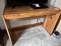 Front view of wooden stand showing overall structure and finish