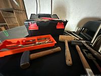 Toolbox, chisels tray, mallets and assorted hand tools on table