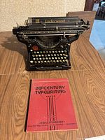 Underwood typewriter front view with instructional book placed in front