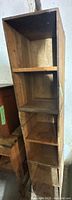vertical view of three attached wooden crates forming shelf