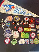 Full lot showing pennant, patches, pins, keychains