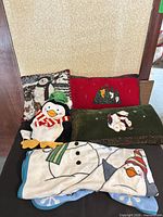 Group shot of four pillows and blanket showing designs and sizes