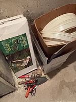 Boxed garden kneeler, edging rolls and hand tools