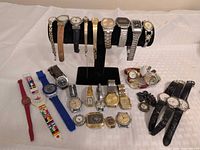 Full lot showing watches on stand and grouped on table