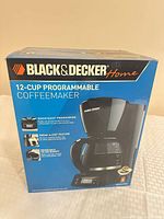 Front of sealed Black+Decker 12-cup programmable coffeemaker box showing brand, capacity and features