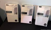 Three sealed Home Styles double fitted sheets on display