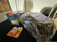 Two corrugated sump pump discharge kits, Imperial vinyl duct box, pack of three fly magnets on table