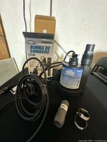 Pump with cord, adapter, hose clamps and box