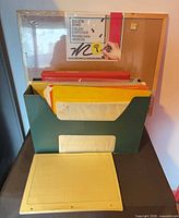 Bulletin board in packaging, desktop file holder with hanging folders, yellow graph paper pack