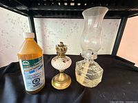 Overall view of both oil lamps and oil bottle