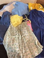 All eight clothing and textile items laid on surface