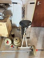 CCM exercise bike with weights stacked beside it