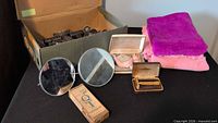 Overview of lot with rollers, mirrors, razors, lotion box and folded towels