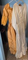 Front view of both dresses on hangers