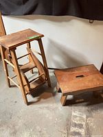 Folding three-step stool and wide step stool on floor