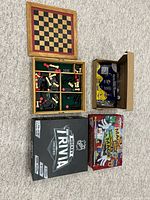 Overall view of chess board, organizer with game pieces, NHL Trivia game box, magic kit boxes