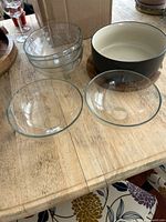 Group shot showing five glass bowls, ceramic bowl, wooden board