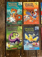 Front covers of four Dragon Masters books: Rise of the Earth Dragon, Swing of the Sun Dragon, Roar of the Thunder Dragon, Search for the Lightning Dragon
