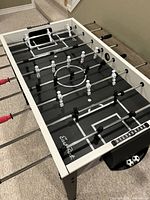 Overall view of foosball table top showing players, rods and markings