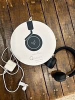 Headphones, box, cable and adapter on wooden surface